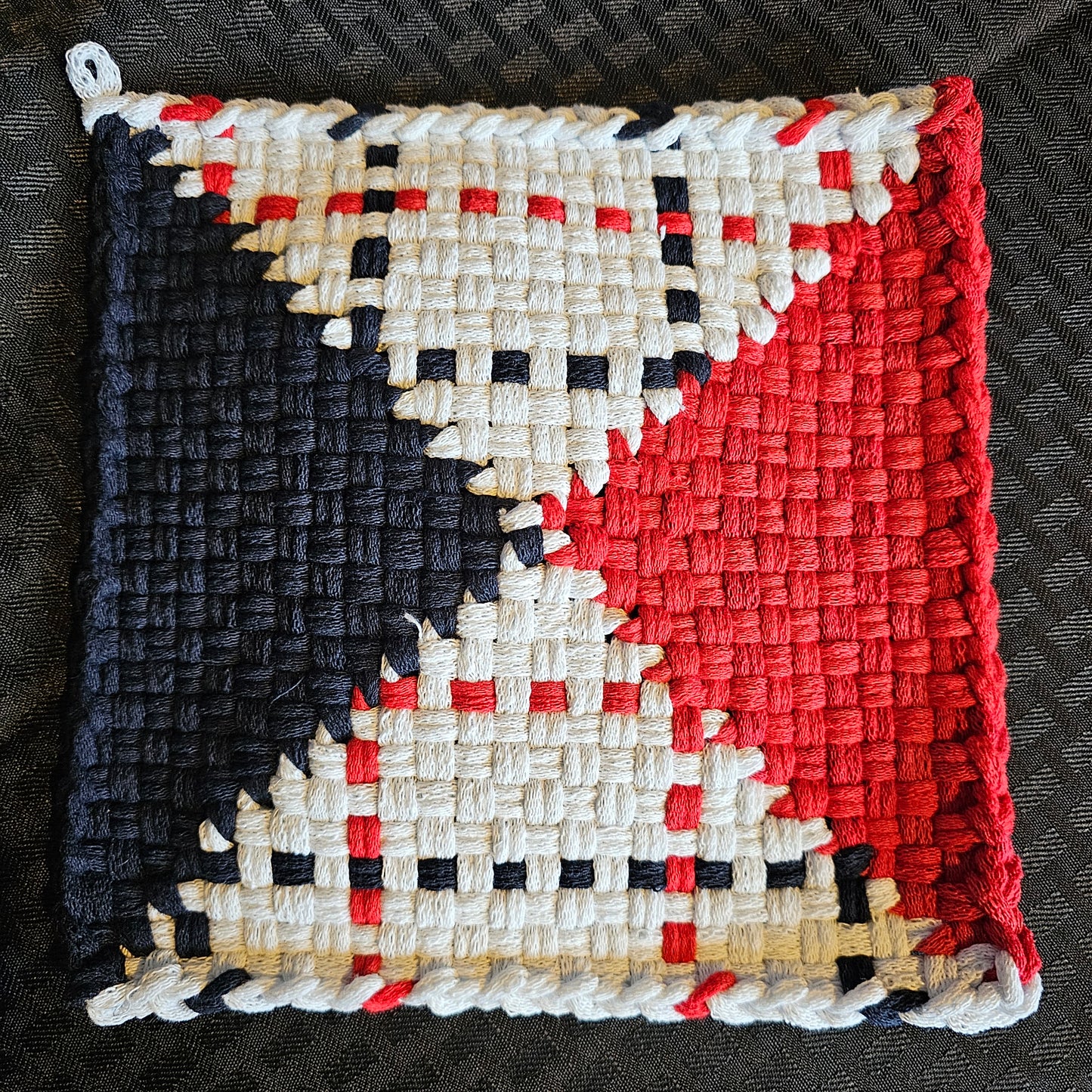 Woven fabric with a geometric pattern on a dark background