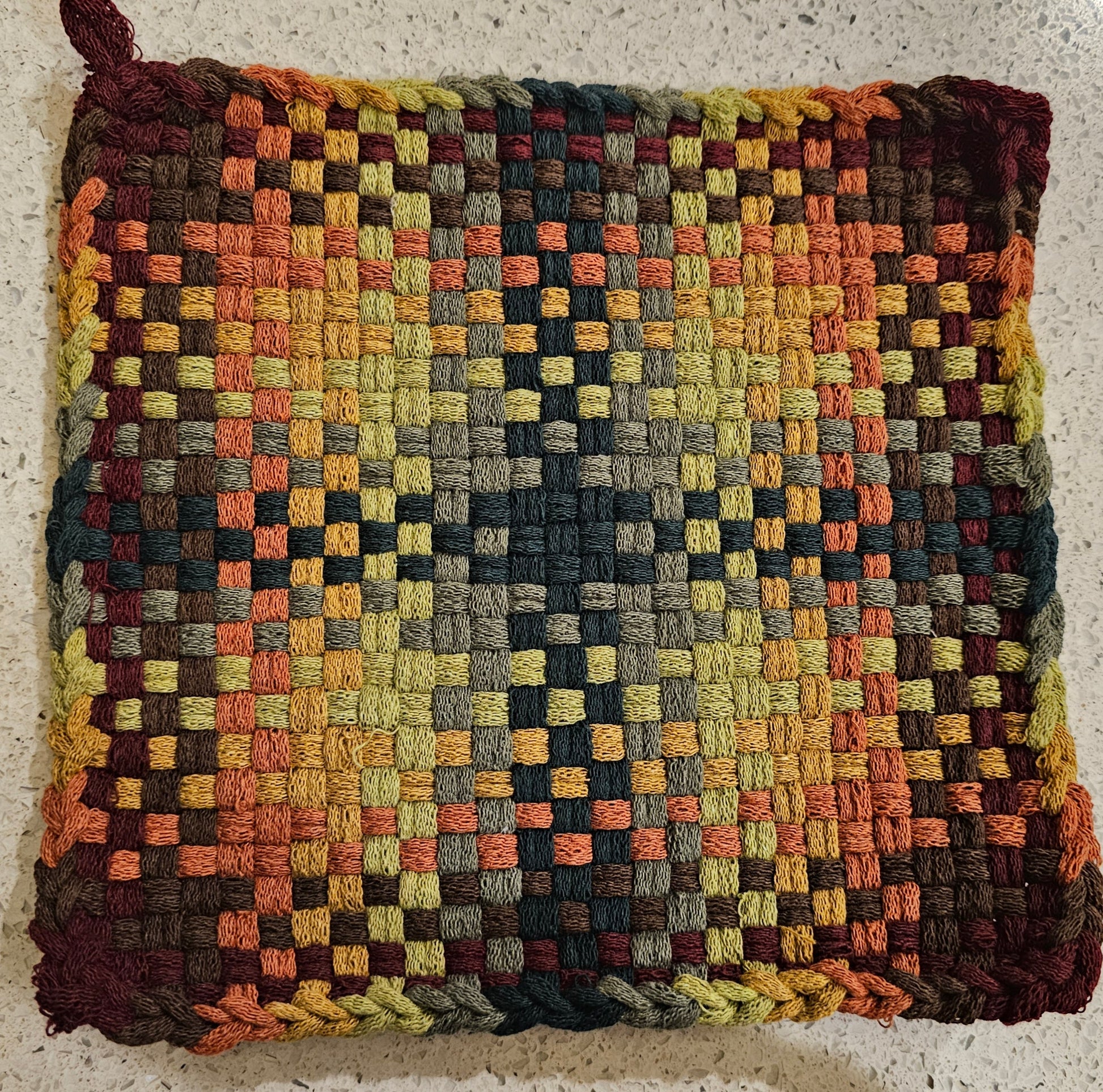Potholder in a checkered pattern in earthy autumn tones 