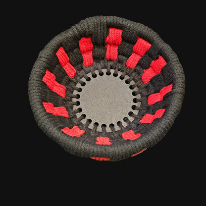 A simple black and red coiled basket . 7x7x3 inches overall