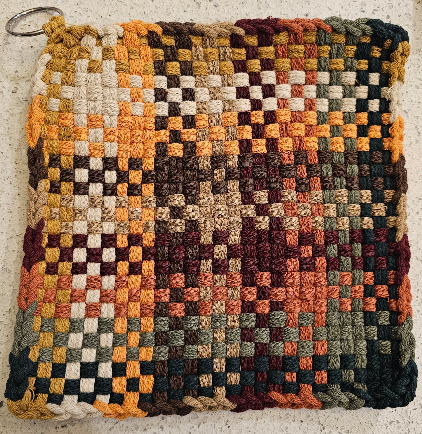 Potholder with a geometric pattern in earthy tones 