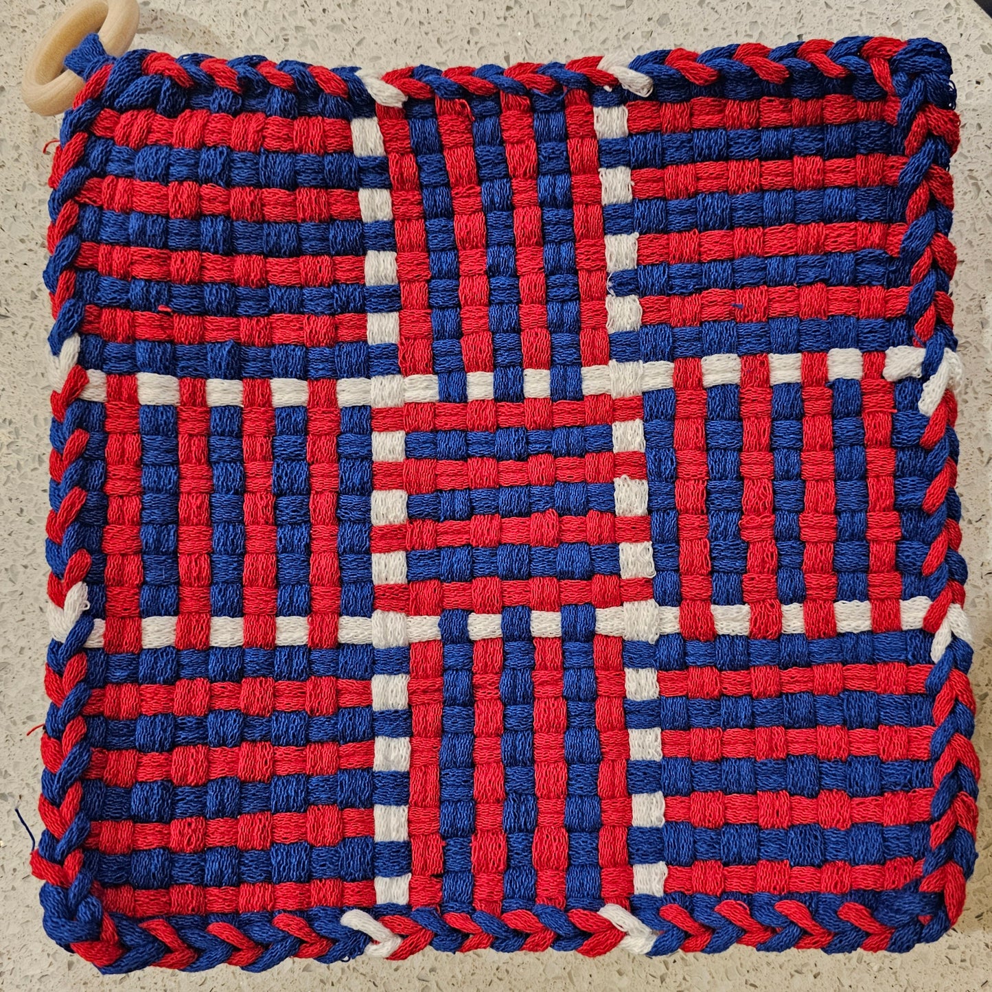 Woven potholder with red, white, and blue pattern 