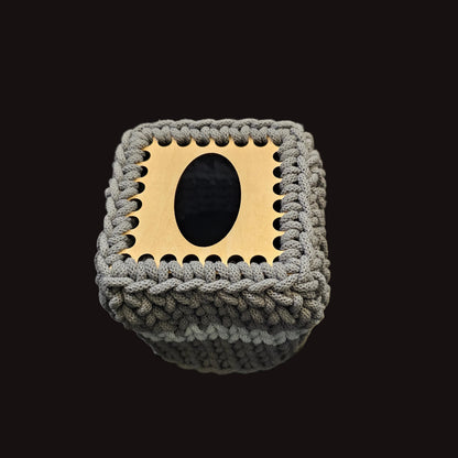 A gray chunky crocheted tissue box cover. 5x5x6 inches overall. Covers the small square tissues. 