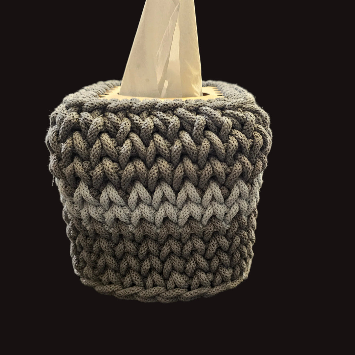 A gray chunky crocheted tissue box cover. 5x5x6 inches overall. Covers the small square tissues. 