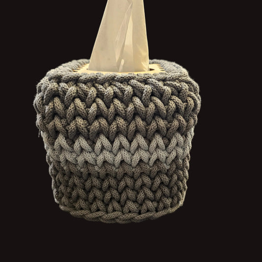 A gray chunky crocheted tissue box cover. 5x5x6 inches overall. Covers the small square tissues. 