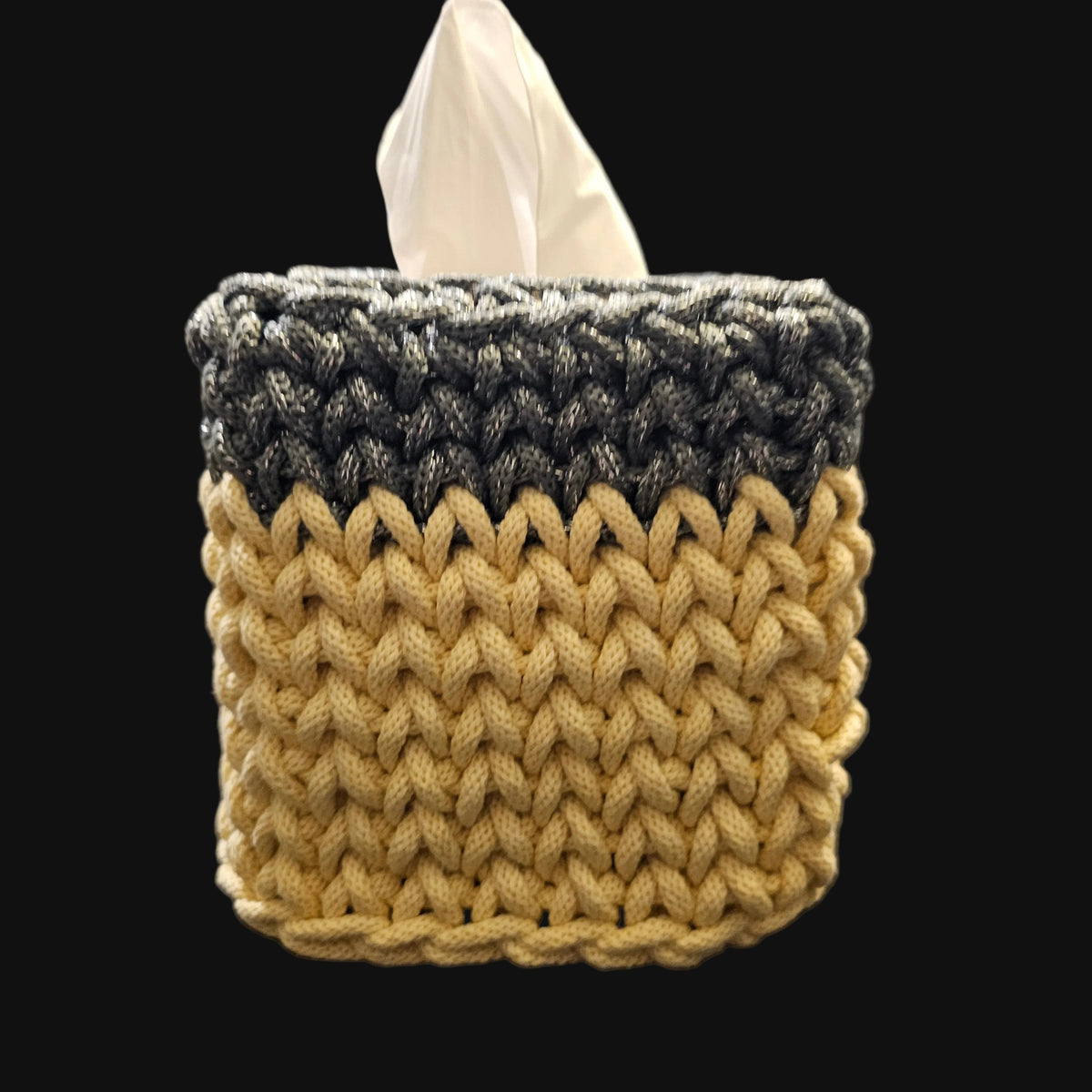 A crocheted tissue box cover in a two-tone design of metallic steel gray and light yellow. 5x5x6 inches overall