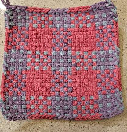 Woven potholder with a checkered pattern in pink and purple 