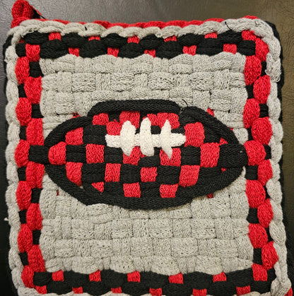 Woven rug with a football design in red, black, and white on a gray background