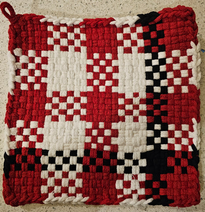 Woven potholder with red, white, and black checkered pattern 