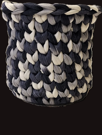 A simple crocheted basket in a color-blocked pattern of black, charcoal gray, and white t-shirt yarn. Perfect for pens/pencils or a small potted plant.