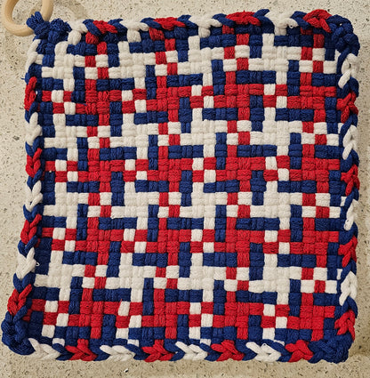 Woven mat with red, white, and blue pattern 