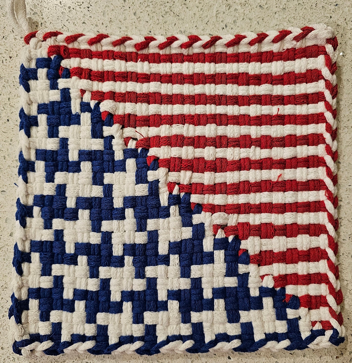 Woven potholder with a pattern resembling the American flag 
