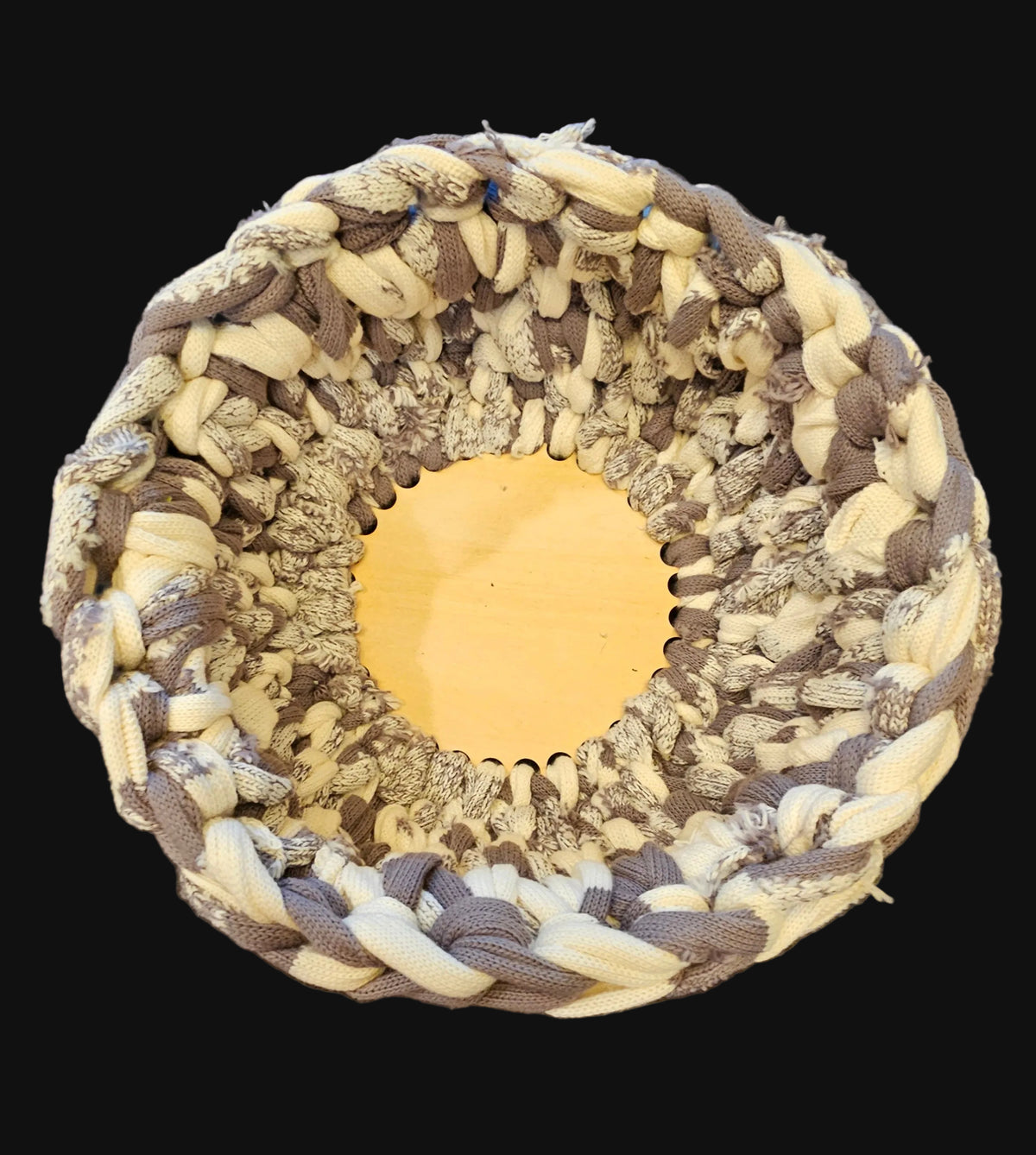 A thick chunky basket made from gray and cream variegated sweater type material. Rustic and irregular in nature. 10x10x5 inches overall
