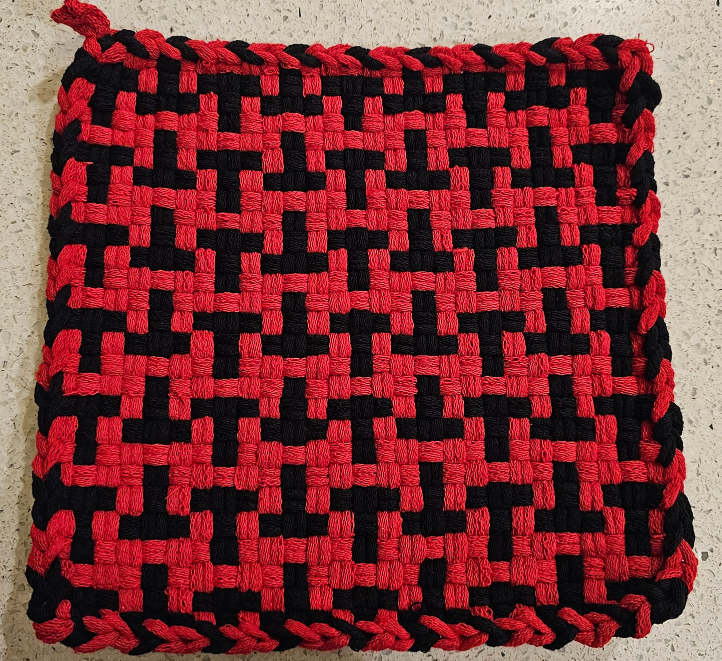 Red and black woven potholder in a "T" formation