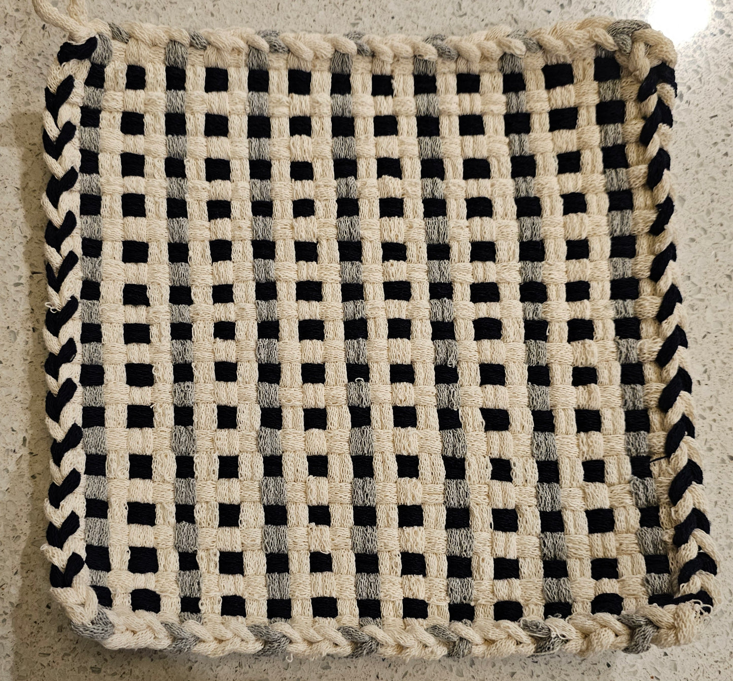 Woven black and white potholder