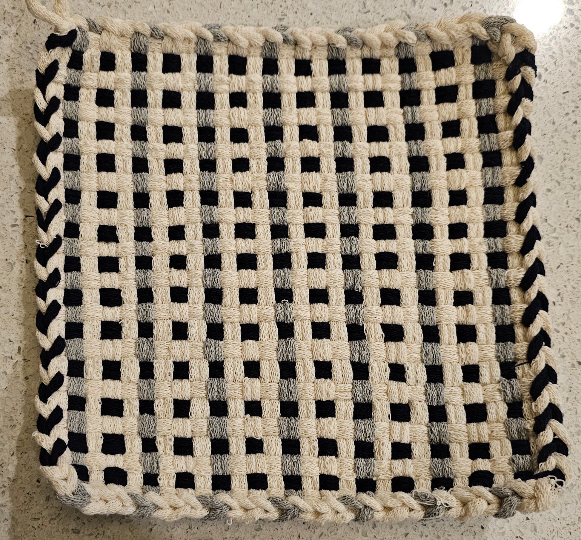 Woven black and white potholder