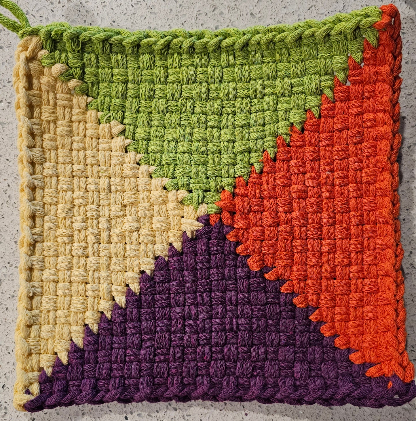 Colorful potholder with green, yellow, orange, and purple