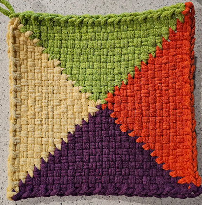 Colorful potholder with green, yellow, orange, and purple