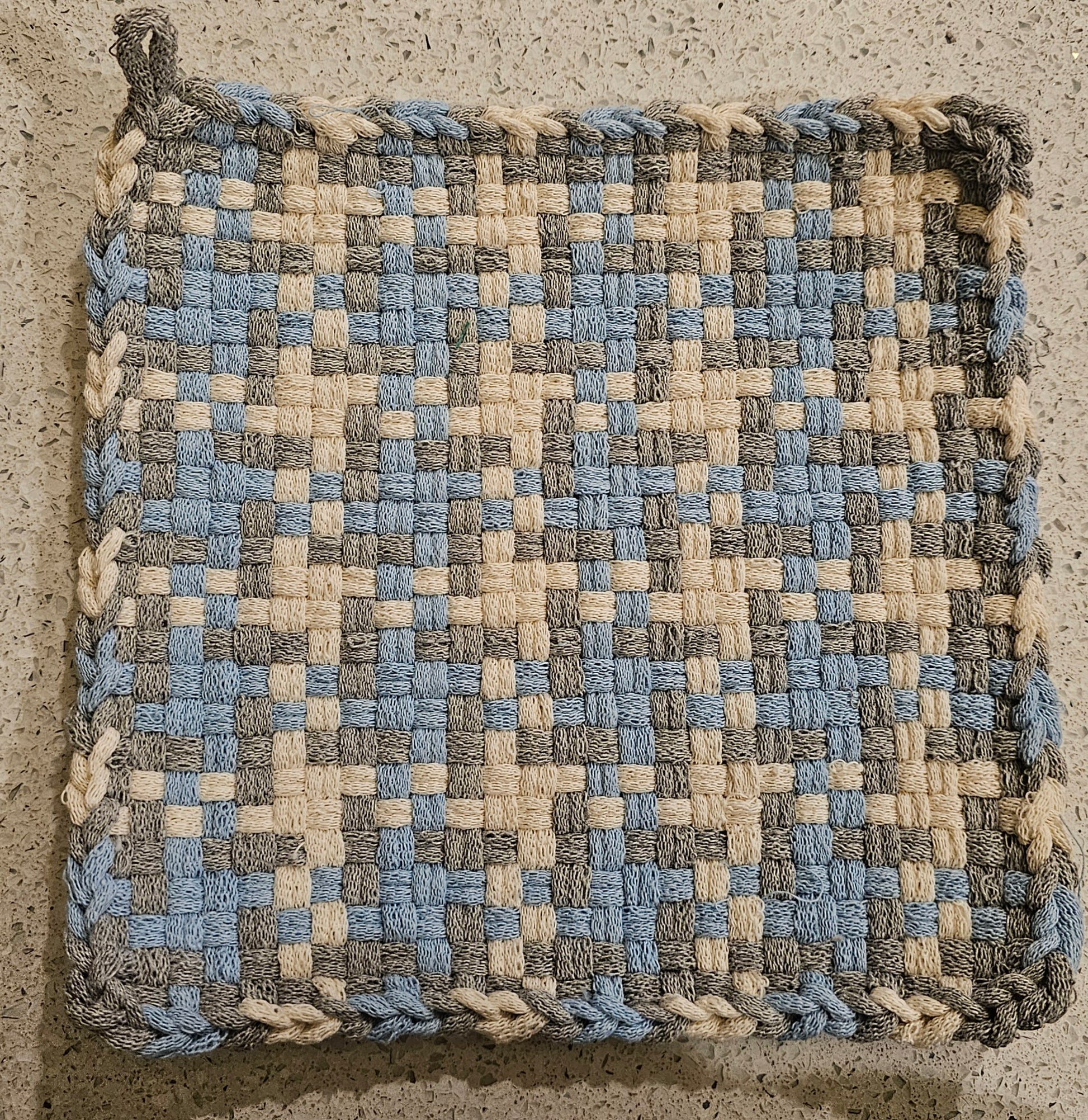 Woven potholder with powder blue, silver and winter white pattern 